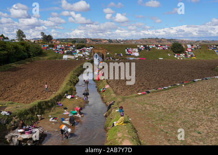 People doing laundry and drying it along the railway, Antsirabe, Central Madagascar, Africa Stock Photo