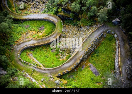 Aerial view of man lying down along the bends of historic Vindhellavegen road, Borgund, Laerdal, Sogn og Fjordane county, Norway, Scandinavia, Europe Stock Photo