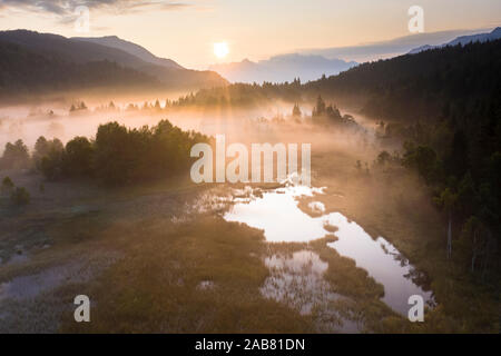 Fog at sunrise over the swamp of Pian di Gembro Nature Reserve, aerial view, Aprica, Valtellina, Lombardy, Italy, Europe Stock Photo