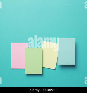 Colorful memo pad, sticky notes on mint background Stock Photo