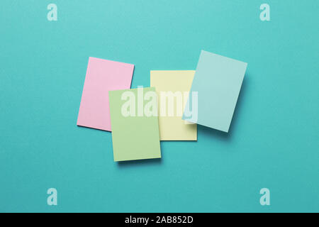 Colorful memo pad, sticky notes on mint background Stock Photo