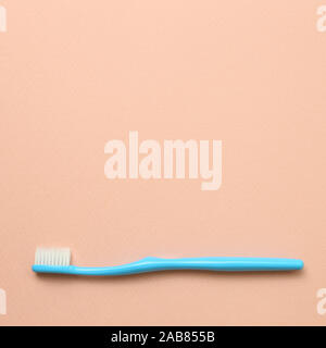 Blue toothbrush on pink background Stock Photo