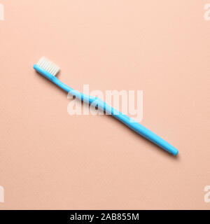 Blue toothbrush on pink background Stock Photo