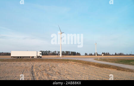 White semi truck carry load on landscape background Stock Photo
