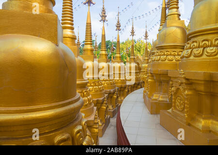 Many gold pagodas at Wat Pa Sawang Bun in Saraburi Province Thailand. There are 500 small pagodas decorated around big pagoda. Stock Photo