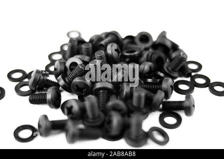 Heap of screws and black metal washers on white background Stock Photo