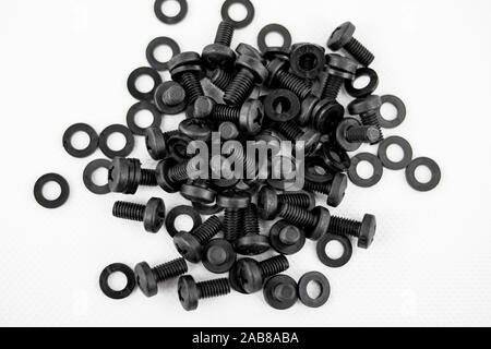 Screws and black washers piled on a white background Stock Photo