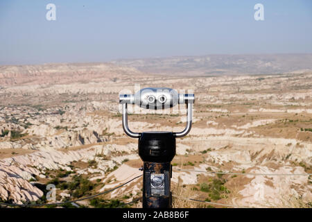 Coin operated binoculars looking over rocky open landscape Stock Photo