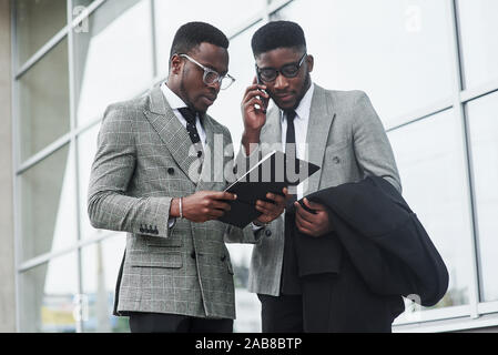 Image of two young businessmen interacting at meeting in office Stock Photo