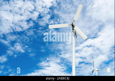 Wind turbine at wind farm on blue sky. Alternative and renewable energy concept. Sustainable electricity. Green energy concept. Small turbine. Clean Stock Photo