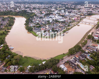 Aerial drone view of Acre river in the amazon and Rio Branco city center buildings, streets, bridges on cloudy winter day. Concept of environment. Stock Photo