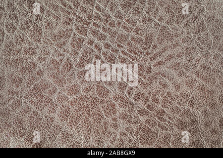 Genuine grainy leather texture closeup, brown color, matte surface, with wrinkles and cracks. Concept of shopping, manufacturing. Fashionable Stock Photo