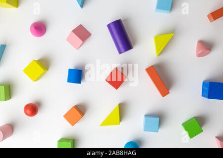 Colorful 3D wooden geometric shapes pattern on white background minimal creative concept. Stock Photo