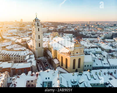 Beautiful Vilnius city panorama in winter with snow covered houses, churches and streets. Aerial evening view. Winter city scenery in Vilnius, Lithuan Stock Photo