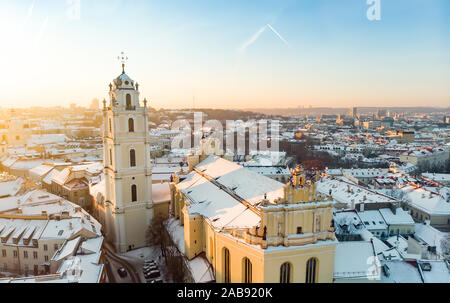 Beautiful Vilnius city panorama in winter with snow covered houses, churches and streets. Aerial evening view. Winter city scenery in Vilnius, Lithuan Stock Photo