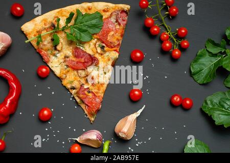 https://l450v.alamy.com/450v/2ab957e/triangular-slice-of-baked-pizza-with-mushrooms-smoked-sausages-tomatoes-and-cheese-next-to-fresh-green-leaves-of-arugula-black-background-flat-2ab957e.jpg