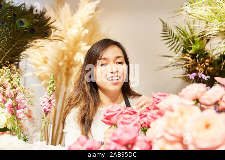 Young Asian woman works in own flower shop as a business Stock Photo