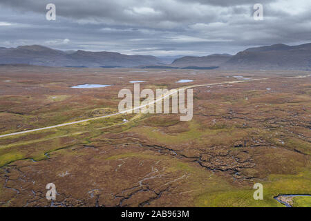 Aerial view over scenic wetland  across A832 road near Fairmore in the Northwest Highlands of Scotland - NC500 Route Stock Photo