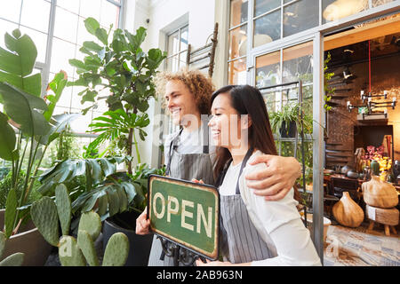 Florists as start-up team at the opening of their own garden center Stock Photo