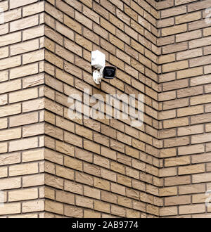 security in a residential area. surveillance video camera on the facade of the building. Stock Photo