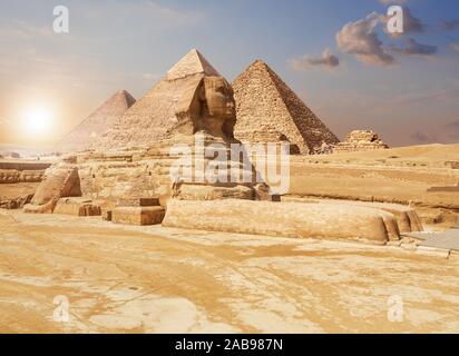 Famous Giza Sphinx and the Pyramids on the background, Egyptian desert.
