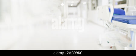 Abstract blurred hospital corridor path way with blank patient bed for  background Stock Photo - Alamy