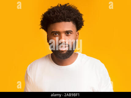 Young smiling african american man over orange background Stock Photo