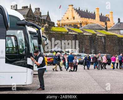 Tourists getting off coach in coach park carpark, castle esplanade, Stirling Castle, Scotland, UK Stock Photo