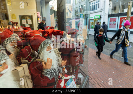 Santa Claus dolls in a shop window display in the build up to Christmas shopping in Cork City, Ireland Stock Photo