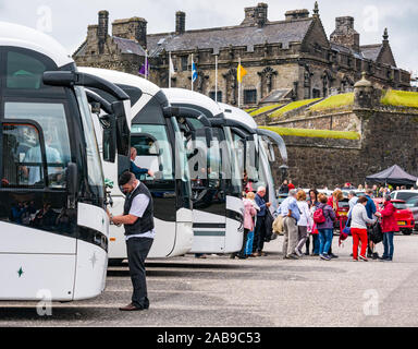 Tourists getting off coaches in coach carpark, castle esplanade, Stirling Castle, Scotland, UK Stock Photo