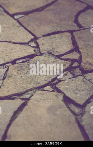 Road surface made of brown natural wild stones. Stock Photo