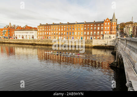 Rowing along the River Lee by St Patricks Quay in Cork City early morning, Ireland Stock Photo