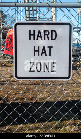 Hard Hat Zone sign on chain link fence at construction site Stock Photo