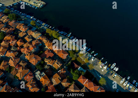 Boats and roofs aerial drone view. Motor boats on the pier of the city of Sozopol Stock Photo