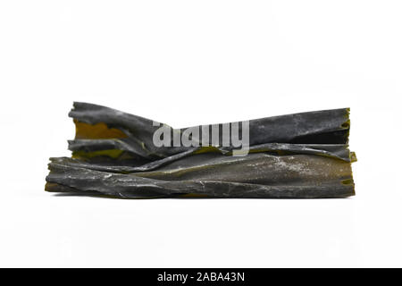 Dried sheets of kombu, an edible kelp algae, also called dasima or haidai, that is widely eaten in East Asia and especially Japan, isolated on white b Stock Photo