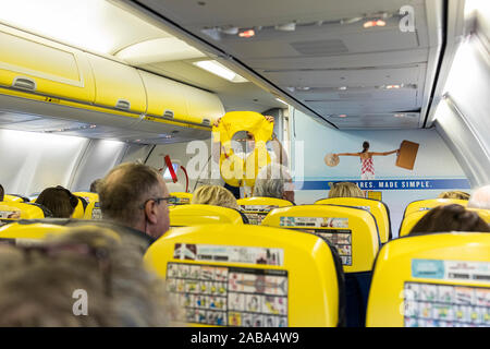 Safety demonstration by cabin crew stewerd on board a Ryanair Boeing ...