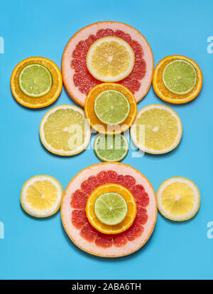 Food concept. Fruit background. Sliced citrus fruit on a blue background. Flat lay, top view. Juicy ripe orange, tangerine, grapefruit, lime and lemon Stock Photo
