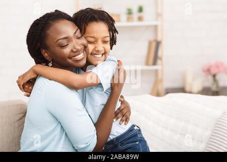 Beautiful black family embrace. Loving father hugging wife and children ...