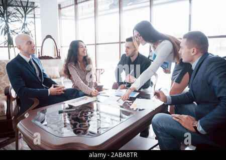 Young team of coworkers making great business discussion in modern office. Teamwork people concept Stock Photo