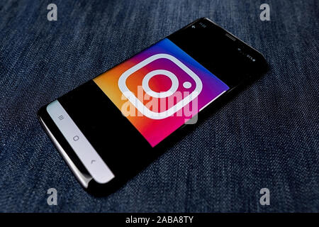 Odessa, Ukraine - October 26, 2019: Instagram app. Instagram logo visible on smartphone screen. Denim background. Soft focus Stock Photo