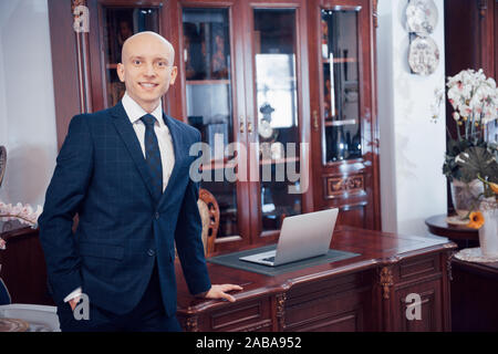 Confident handsome businessman sitting in luxury interior Stock Photo