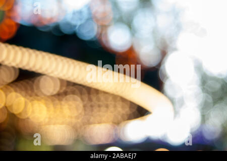 blur view of a carousel at a fun fair at night - bokeh background Stock Photo