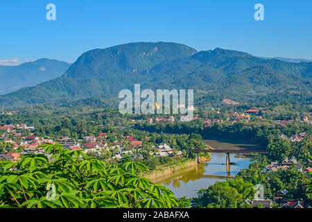 A high view from Phou Si Hill,  Laos,  across the bridge to the colourful roofs and hills beyond Stock Photo