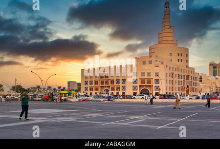 Doha,Qatar-November 23,2019: Al-Fanar Qatar Islamic Cultural Center daylight exterior view with people and cars in the street in foreground Stock Photo