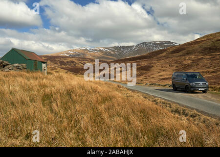 VW Campervan parked in passing place on a remote and pretty road in the ...