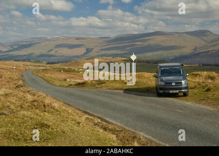 VW Campervan parked in passing place on a remote and pretty road in the ...