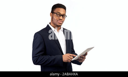 Black guy in suit standing with tablet Stock Photo