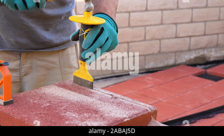 Tile cutter industry equipment.  Worker cutting paving tiles for laying on the terrace Stock Photo