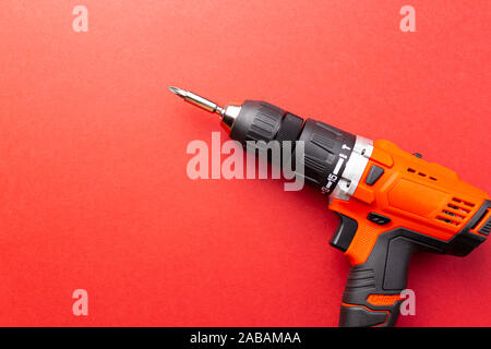 Screw driver with batteries on red background with place for text Stock Photo