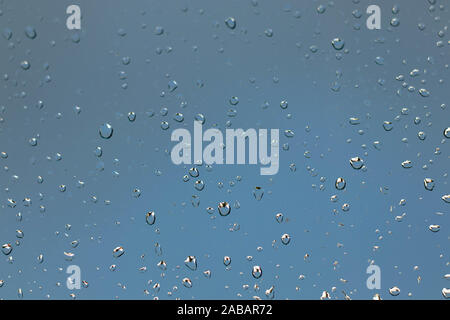 Coruna / Spain - November 5 2019: Rain drops on a window against a thundery gray sky Stock Photo